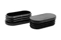 Two black plastic oval tube inserts. Both standing up, showing opposite ends.