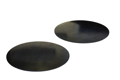 Angled view of two self adhesive rubber discs.
