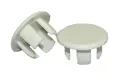 Two white plastic panel plugs. One standing up, one at an angle.