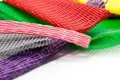 A selection of heavy duty, plastic protecting netting. In various sizes. Pink, Purple, Grey, Red, Yellow and Green.