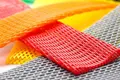 A selection of high stretch, plastic protecting netting. In various sizes. Grey, Red, Yellow, Orange and Green.