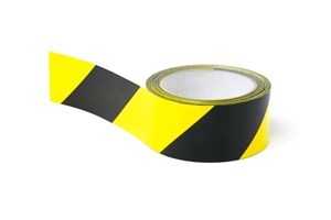Reel of hazard warning tape in black and yellow stripes.