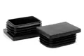 Two black plastic rectangular tube inserts. Both standing up, showing opposite ends.