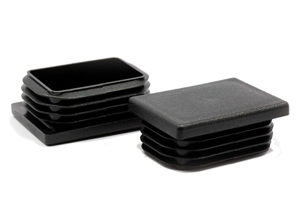 Two black plastic rectangular tube inserts. Both standing up, showing opposite ends.