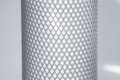 Heavy Duty, grey plastic protective netting, stretched over a tube.