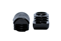 Two black plastic square tube inserts with domed tops. Both standing up, one on each end.