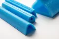 Expanded blue foam packaging in different shapes and sizes.