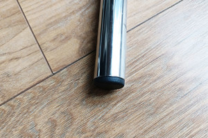 A round chrome metal tube with a black plastic tube insert fitted in the end.
