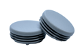 Two grey plastic round tube inserts. One is at an angle on top of the other
