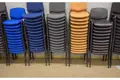 Piles of stacked chairs in various colours used to demonstrate stacking chair buffers.