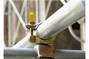 Scaffold clamp with yellow protection cap on the bolt.