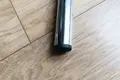 Top-down view of a black round injection-moulded insert foot fitted to the base of a metal tube leg.