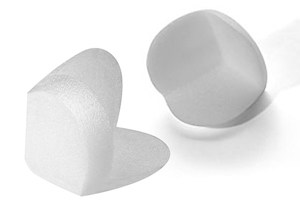 Pair of white foam corner protectors.
