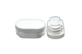 Two white plastic oval tube inserts. Both standing up, showing opposite ends.