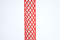 Heavy Duty, red plastic protective netting, stretched over a tube.