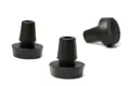 Three rubber push in feet. Two standing up and one on its side.