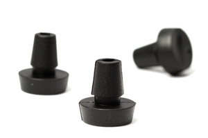 Three rubber push in feet. Two standing up and one on its side.