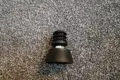 A black plastic round tube insert with threaded hole. With an adjustable foot attached.