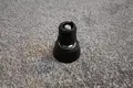 Angled view of A black plastic round tube insert with threaded hole. With an adjustable foot attached.
