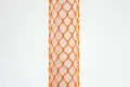 Orange plastic protective netting, stretched over a tube.