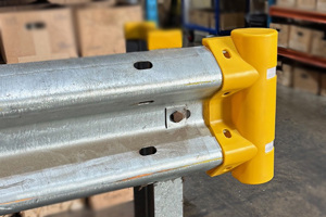 Pedestrian end safety cap fitted to armco barrier. Yellow cap with rounded safety end with reflectors.