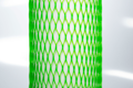 High Stretch, green plastic protective netting, stretched over a tube.
