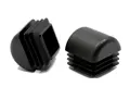 Two black plastic square tube inserts with domed tops. One standing up, the other on its side.