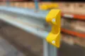Yellow plastic armco cap with reflectors fitted to armco barrier section.