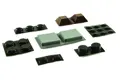 Selection of different shaped self adhesive feet. Domed, square, cylindrical and hemispherical. In black, grey and brown.