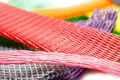 A selection of plastic protective netting. In various sizes. Pink, Red, Yellow, Orange, Grey and Green.