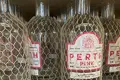 Bottles of Gin, covered in plastic protective netting.