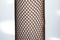 Heavy Duty, brown plastic protective netting, stretched over a tube.