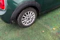 A car parked on top of plastic mesh that has been laid on grass.