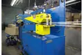 Chinese plastic extrusion machine, blue and yellow producing a clear tube.