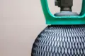 Close up of a gas cylinder covered in black plastic protective netting.