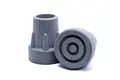 Side view of two grey rubber injection moulded crutch-style feet with a large flange base.