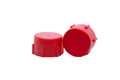 Side-by-side view of two red, LDPE British Standard Pipe threaded caps—one upright and one tilted to display the flat closed end.