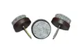 Three nail in feet. Grey felt on brown plastic base with metal nail.
