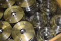 Metal parts in a wooden pallet. Separated by plastic mesh
