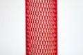 Red plastic protective netting, stretched over a tube.