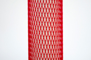 Red plastic protective netting, stretched over a tube.