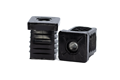 Two black plastic square tube inserts with metal threaded holes. One standing up, one on its side.