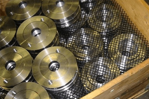 Metal parts in a wooden pallet. Separated by plastic mesh