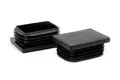 Two black plastic rectangular tube inserts. Both standing up, showing opposite ends.